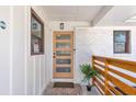 Welcoming front porch featuring a modern wood door, sleek railing, and painted white brick at 2419 Edgewater Sw Dr, Atlanta, GA 30311