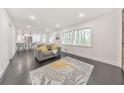 Bright living room featuring an open floor plan, sleek dark floors, and large windows at 2419 Edgewater Sw Dr, Atlanta, GA 30311