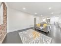 Bright living room featuring an open floor plan, sleek dark floors, and exposed brick at 2419 Edgewater Sw Dr, Atlanta, GA 30311