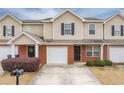 Inviting townhome exterior with black accents, highlighting the attached garage and cozy landscaping at 453 Tara Commons Cir, Loganville, GA 30052