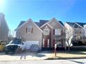 Traditional two-story home with neutral siding, red shutters, two-car garage and well-maintained landscaping at 929 Bexhill Dr, Lawrenceville, GA 30043