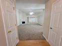 Spacious living room with a fireplace and large windows, offering a bright and welcoming atmosphere at 983 Noble Oak Ct, Lawrenceville, GA 30046