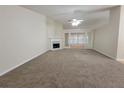 Bright living room featuring neutral carpet, a fireplace, and recessed lighting, creating a comfortable space at 983 Noble Oak Ct, Lawrenceville, GA 30046