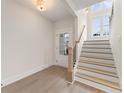 Bright entryway with hardwood floors, staircase, and a front door with glass panels at 2722 Byess Ct, Marietta, GA 30064