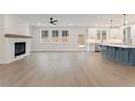 Spacious living room with fireplace and adjacent kitchen featuring a blue island and white cabinetry at 2722 Byess Ct, Marietta, GA 30064