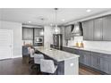 Stylish kitchen featuring granite countertops, stainless steel appliances, pendant lighting, and ample storage space at 3139 Stonegate Sw Dr, Atlanta, GA 30331