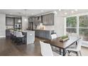 Open-concept kitchen and dining area featuring gray cabinetry, granite countertops, and stainless steel appliances at 3139 Stonegate Sw Dr, Atlanta, GA 30331