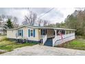 Attractive home with an expansive front porch and eye-catching blue shutters providing curb appeal at 10 Creek Se Dr, Cartersville, GA 30121