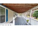 Long covered front porch with painted wood decking and white railing offering outdoor space at 10 Creek Se Dr, Cartersville, GA 30121