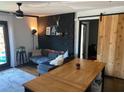 Stylish living room featuring a decorative brick wall, sliding barn door, and comfortable seating area at 323 Ne 8Th Ne St, Atlanta, GA 30309