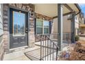 Inviting front porch with stone accents and a black front door, complete with iron railings at 4525 Hopewell Manor Dr, Cumming, GA 30028