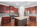 Bright kitchen featuring stainless steel appliances, granite countertops, and an island for food preparation at 4525 Hopewell Manor Dr, Cumming, GA 30028