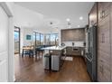 Open concept kitchen with stainless steel appliances and hardwood floors at 270 17Th Nw St # 2601, Atlanta, GA 30363
