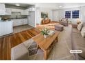 Bright, staged living room featuring hardwood floors, neutral paint, and an adjoining kitchen at 4679 Bartlett Rd, Forest Park, GA 30297