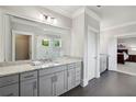 Bathroom featuring double sink vanity with granite countertops and herringbone tile flooring at 765 Hembree Rd, Alpharetta, GA 30076