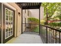 Cozy outdoor patio space with wrought iron railing and view of mature trees at 3527 Essex Ave # 74, Atlanta, GA 30339