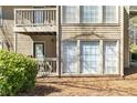 Exterior view featuring a small balcony, large windows, and mature landscaping at 1506 Country Park Se Dr, Smyrna, GA 30080