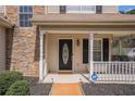 Inviting front porch with stacked stone accents, a 'Welcome' mat, and ADT security sign at 190 The Falls Blvd, Covington, GA 30016
