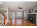 Spacious living room with hardwood floors, fireplace, and bright natural light at 190 The Falls Blvd, Covington, GA 30016