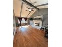 Spacious living room with vaulted ceilings, brick fireplace, and hardwood flooring at 4034 Weeks Nw Dr, Kennesaw, GA 30144