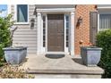 Inviting front entrance with decorative potted plants at 7335 Treyland Ct, Cumming, GA 30041