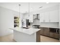 Contemporary kitchen featuring a large island, stainless steel appliances, and stylish pendant lighting at 775 Juniper Ne St # 334, Atlanta, GA 30308