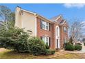 Attractive two-story brick and siding home with a manicured front yard at 5053 Kingsbridge Pass, Powder Springs, GA 30127