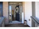 Inviting entryway with decorated door, 'Welcome' sign, and view into dining room with hardwood flooring at 5315 Austrian Pine Ct, Cumming, GA 30040