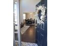 Inviting entryway with decorated door and view into dining room with hardwood flooring at 5315 Austrian Pine Ct, Cumming, GA 30040