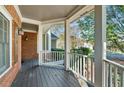 Cozy porch with white railings and view of the surrounding landscape at 4711 Oakleigh Manor Dr, Powder Springs, GA 30127