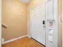 Entryway with wood-look flooring, coat hooks, and a sidelight window next to the front door at 2322 Coach Way, Jonesboro, GA 30236