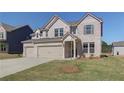 Charming two-story home featuring a three car garage and manicured lawn at 2740 Dolce Rd, Dacula, GA 30019