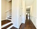 Inviting hallway with hardwood floors, white trim, and staircase leading to the upper level at 2795 Greenbridge Drive, Norcross, GA 30071