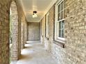 Long covered patio area features brick columns, a whitewashed ceiling, and outdoor lighting at 3081 Oak Dr, Lawrenceville, GA 30044