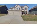 Beautiful two-story home with a three-car garage, complemented by a well-maintained lawn at 2761 Dolce Rd, Dacula, GA 30019