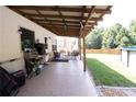 Inviting covered patio area featuring a dining set, storage and view of the backyard and above ground pool at 309 Daffodil Dr, Temple, GA 30179