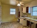 Functional kitchen with laminate countertops, white cabinets, and a window at 70 Rockmart Nw Dr, Atlanta, GA 30314