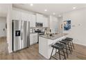 Eat-in kitchen boasts stainless appliances, island with seating, and bright white cabinets at 1330 Magnolia Bend Way # 306, Jonesboro, GA 30238