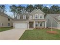 Charming two-story home features a welcoming front porch, attached garage, and professionally landscaped yard at 250 Arnewood Cir, Mcdonough, GA 30253