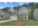 Attractive two-story home showcasing a well-maintained lawn, attached garage, and inviting front porch at 250 Arnewood Cir, Mcdonough, GA 30253