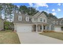 Beautiful home with a well-kept lawn, attached two-car garage, and cozy covered porch entrance at 250 Arnewood Cir, Mcdonough, GA 30253