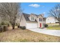 Charming two-story home with a manicured lawn, two-car garage, and a vibrant red front door at 2549 Greenville Way, Decatur, GA 30034