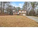 Daytime view of a charming two-story brick home with an attached single car garage at 620 Bell Se Rd, Conyers, GA 30094