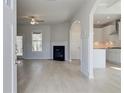 Bright living room with fireplace, hardwood floors and entrance to kitchen at 132 Felicity Pike, Locust Grove, GA 30248