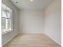 Bright, light-filled room features large window and hardwood floors at 132 Felicity Pike, Locust Grove, GA 30248