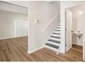 Welcoming entryway features hardwood floors, stairs and a conveniently located half bathroom at 4593 Parkway Cir, Atlanta, GA 30349
