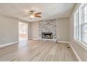 Bright living room with stone fireplace, modern flooring and abundant natural light at 322 Corley Cir, Hiram, GA 30141