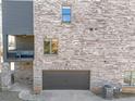 Rear view of brick townhome with a covered patio and convenient garage access at 2850 Stonehall Se Ct, Smyrna, GA 30080