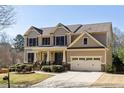 Attractive two-story home with an attached two-car garage and a well-maintained lawn at 4012 Grand Park Ne Dr, Suwanee, GA 30024