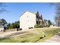 A two-story home situated on a verdant lot, showcasing its architectural design at 4012 Grand Park Ne Dr, Suwanee, GA 30024